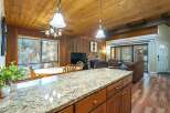 Step into this inviting home featuring a cozy living space with a fireplace and a well-equipped kitchen.