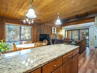 Step into this inviting home featuring a cozy living space with a fireplace and a well-equipped kitchen.