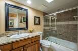 Step into this inviting bathroom, featuring a stylish vanity with a granite countertop and a sleek sink.