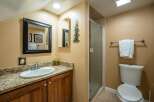 This charming bathroom features a stylish vanity with a granite countertop and a sleek, modern sink.