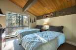 This cozy bedroom features two twin beds, perfect for guests or a shared space.