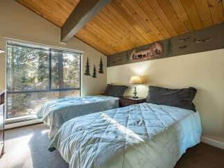 This cozy bedroom features two twin beds, perfect for guests or a shared space.