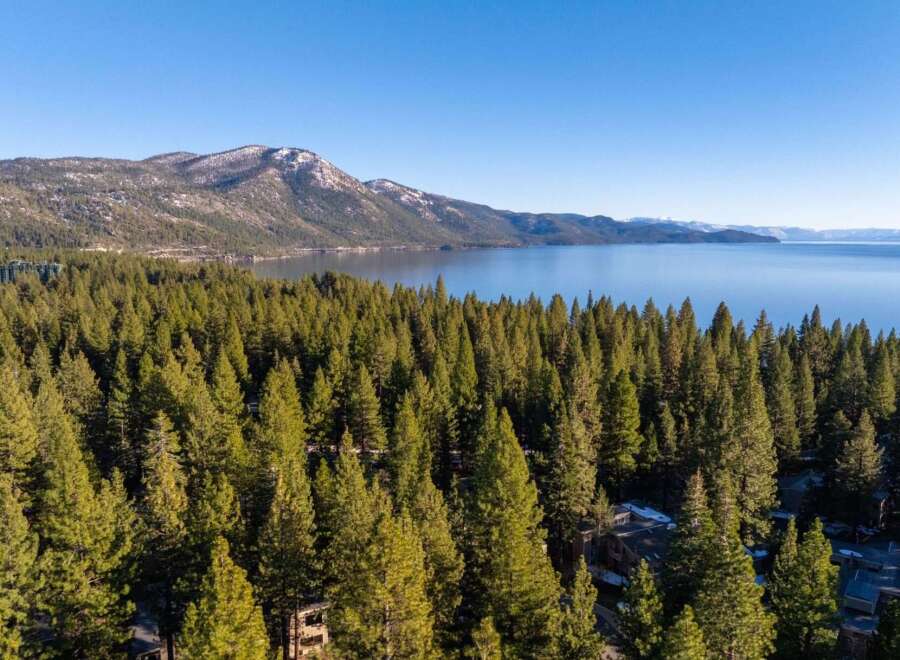 Discover a stunning property nestled amidst a lush forest with breathtaking lake views.