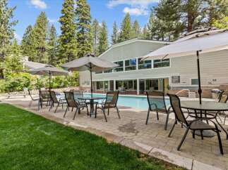 Enjoy the ultimate relaxation at this stunning property featuring a refreshing pool and comfortable outdoor seating.