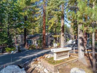Discover the charm of Forest Pines Condominiums, nestled amidst towering trees.