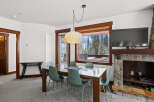 This stunning property features a modern dining area with a glass-top table and stylish chairs.