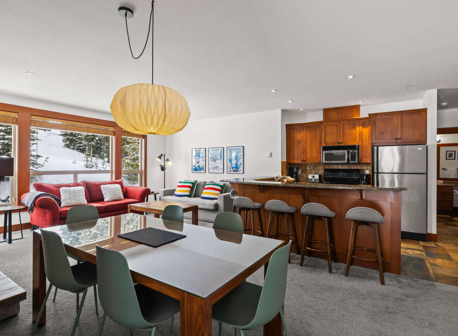 Experience luxury living in this stunning property, featuring a modern kitchen with stainless steel appliances and a breakfast bar.