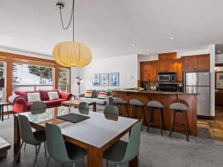 Experience luxury living in this stunning property, featuring a modern kitchen with stainless steel appliances and a breakfast bar.