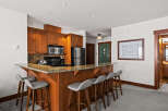 This stunning kitchen features a beautiful breakfast bar with seating, perfect for casual dining or entertaining.