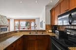 Step into this stunning kitchen, boasting elegant wooden cabinetry and a sleek black stovetop.