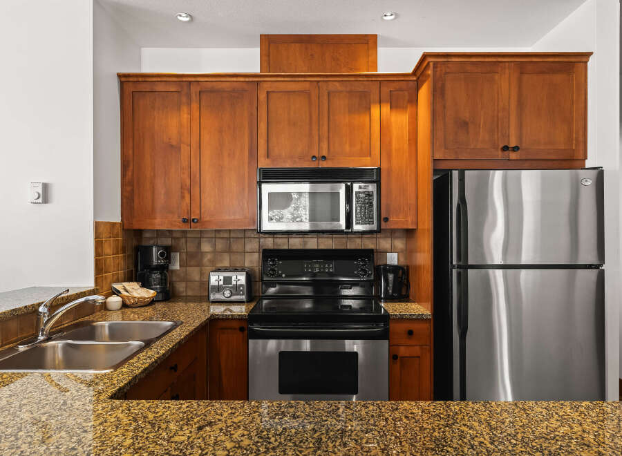 This stunning kitchen boasts beautiful wooden cabinetry, providing ample storage and a warm, inviting atmosphere.