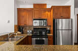 This stunning kitchen boasts beautiful wooden cabinetry, providing ample storage and a warm, inviting atmosphere.
