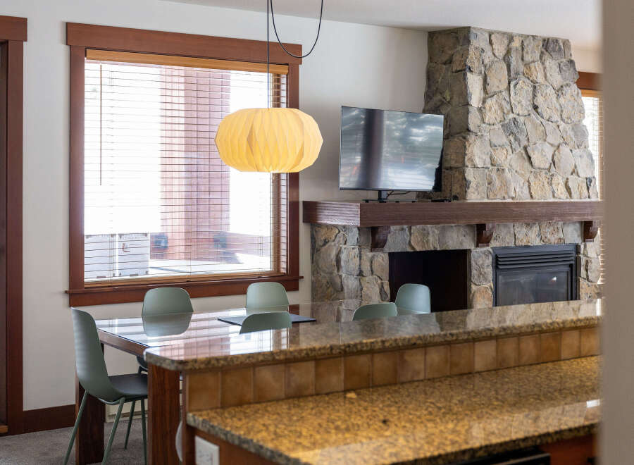 This stunning property boasts a cozy living space with a stone fireplace, perfect for relaxing evenings.