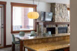 This stunning property boasts a cozy living space with a stone fireplace, perfect for relaxing evenings.