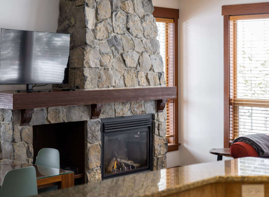 Experience the warmth and charm of this stunning property, featuring a beautiful stone fireplace as the focal point.