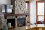 Experience the warmth and charm of this stunning property, featuring a beautiful stone fireplace as the focal point.