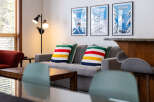 This cozy living space features a comfortable gray sofa adorned with colorful striped pillows, creating a welcoming atmosphere.