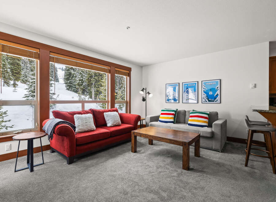 This cozy living space offers a warm and inviting atmosphere, perfect for relaxing after a day on the slopes.