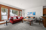 This cozy living space offers a warm and inviting atmosphere, perfect for relaxing after a day on the slopes.