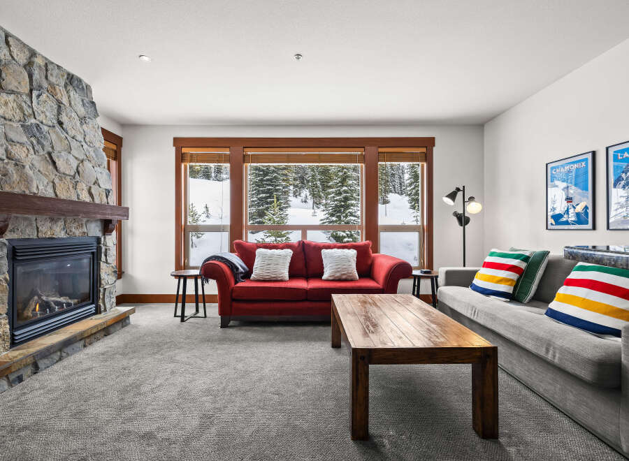 This stunning living room features a cozy fireplace with a stone facade, perfect for those chilly evenings.