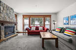 This stunning living room features a cozy fireplace with a stone facade, perfect for those chilly evenings.