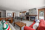 This stunning property boasts a cozy living room with a stone fireplace, perfect for relaxing evenings.