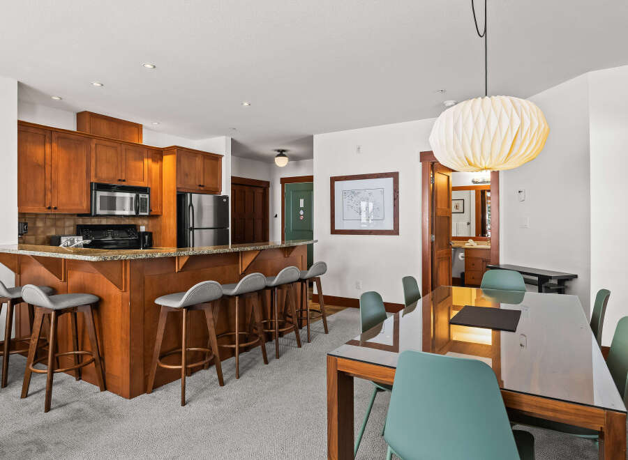 This stunning property boasts a modern kitchen with sleek cabinetry and stainless steel appliances, perfect for culinary enthusiasts.