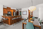 This stunning property boasts a modern kitchen with sleek cabinetry and stainless steel appliances, perfect for culinary enthusiasts.