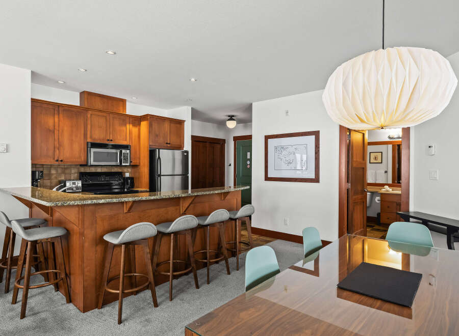 This stunning property boasts a modern kitchen with stainless steel appliances and a breakfast bar, perfect for entertaining.