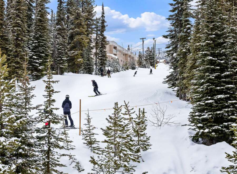 Enjoy the winter wonderland from this stunning property! Nestled in a snowy landscape, this home offers easy access to skiing and snowboarding.
