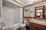 This stunning bathroom features a modern design with a sleek white bathtub and shower.