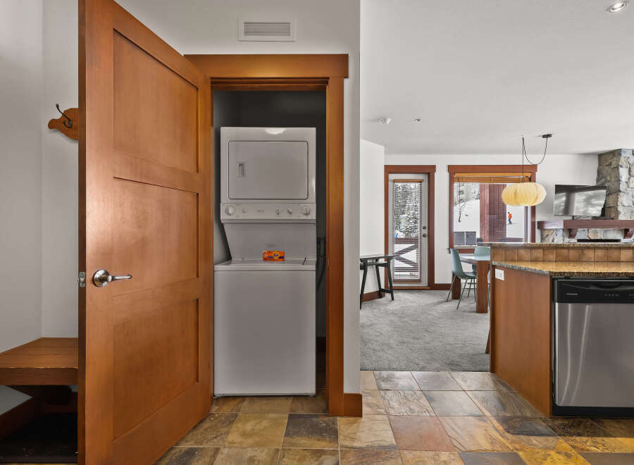 This stunning property boasts a convenient laundry area with a stacked washer and dryer, perfect for modern living.