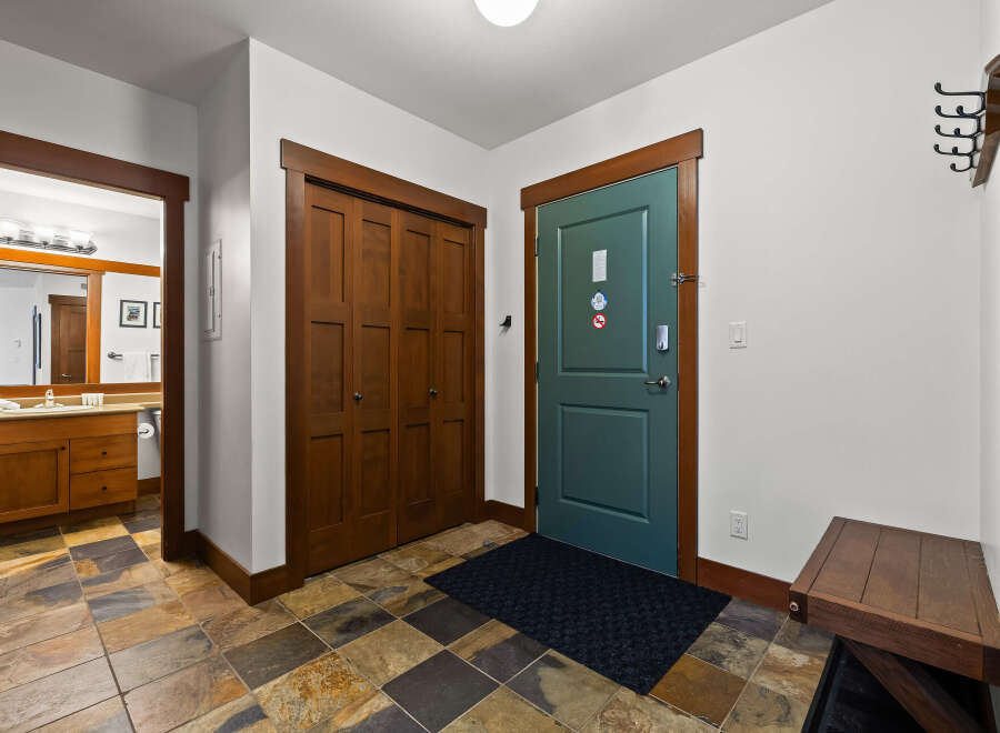 Step into this inviting entryway, showcasing beautiful wooden doors and trim that exude warmth and character.