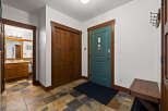 Step into this inviting entryway, showcasing beautiful wooden doors and trim that exude warmth and character.