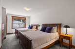 This cozy bedroom features two comfortable beds with plush pillows, perfect for a relaxing stay.
