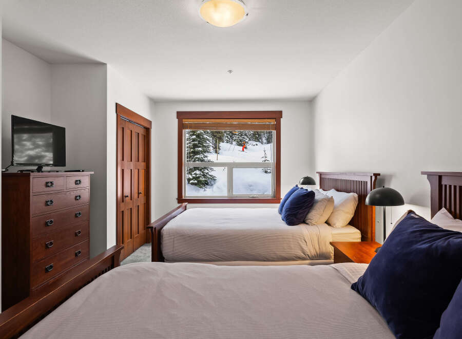 This cozy bedroom features two comfortable beds, perfect for a relaxing stay.