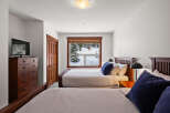 This cozy bedroom features two comfortable beds, perfect for a relaxing stay.