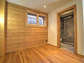 This stunning property boasts a warm and inviting interior with beautiful wooden accents throughout.