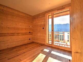 This stunning property boasts a warm and inviting interior with beautiful wooden walls and flooring.