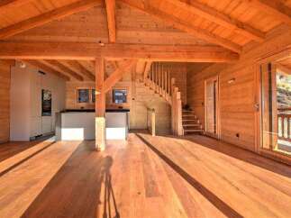 Experience the warmth of this stunning wooden interior, perfect for a cozy and inviting atmosphere.