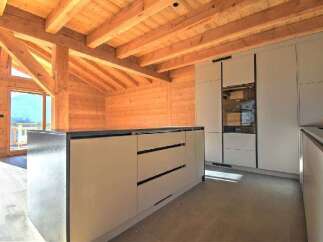 This stunning kitchen boasts a modern design with sleek cabinetry and a spacious island, perfect for culinary enthusiasts.