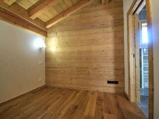 This stunning property boasts a warm and inviting interior with beautiful wooden accents throughout.
