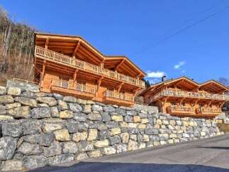 Discover the charm of these stunning wooden chalets nestled in a picturesque mountain setting.