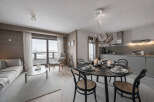 Experience luxury living in this stunning property, featuring a modern kitchen and a cozy living area.