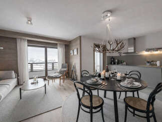 Experience luxury living in this stunning property, featuring a modern kitchen and a cozy living area.
