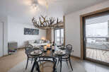 Experience luxury living in this stunning property, featuring a beautifully designed dining area with a unique antler chandelier.