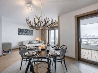 Experience luxury living in this stunning property, featuring a beautifully designed dining area with a unique antler chandelier.