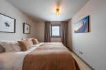 This cozy bedroom features two twin beds, perfect for a comfortable stay.