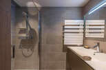 This modern bathroom features a sleek shower with a glass enclosure and a stylish vanity.