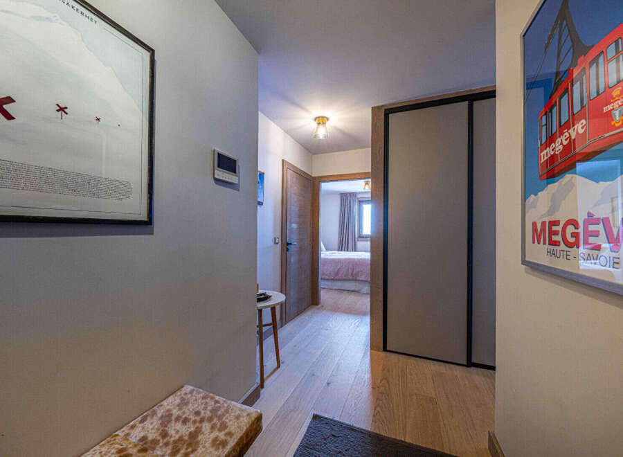 Step into this inviting hallway, featuring a blend of modern design and warm, natural elements.